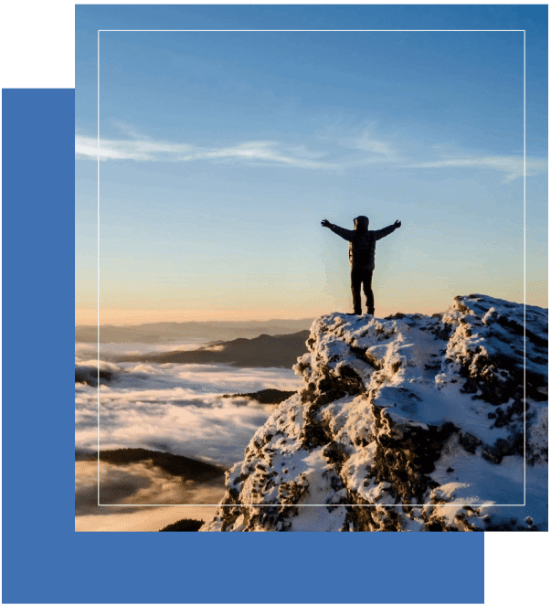 A person standing on top of a snow covered hill.