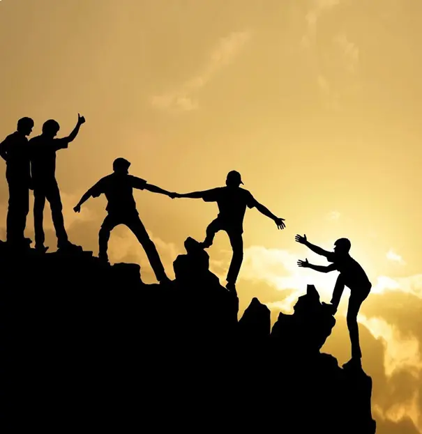 A group of people standing on top of a mountain.